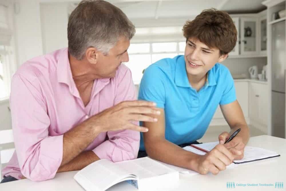 A father helping his son with college homework.