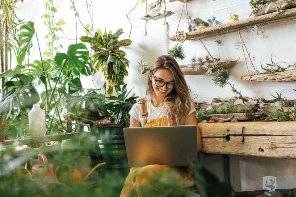 Woman using laptop in a garden