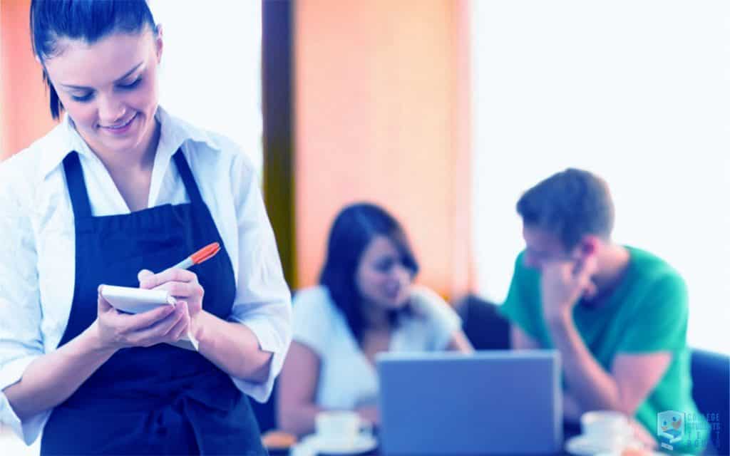 Beautiful student restaurant server doing her job